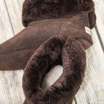 British made mocha house boots on a wooden background, fur collar
