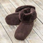 British made mocha house boots on a wooden background, fur collar
