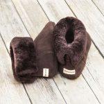British made mocha house boots, on a wooden background with the fur collar rolled down